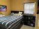 Cozy bedroom featuring a striped comforter and ample storage at 110 Country Club Cir, Sanford, FL 32771