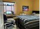 Bright bedroom with striped bedding and a workspace at 110 Country Club Cir, Sanford, FL 32771
