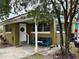 Inviting front porch with seating area and landscaping at 110 Country Club Cir, Sanford, FL 32771