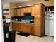 Kitchen with wood cabinets, tile floor and a full suite of appliances at 110 Country Club Cir, Sanford, FL 32771