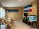 Bright living room featuring a comfortable sofa and large wall art at 110 Country Club Cir, Sanford, FL 32771