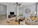 Living room with gray walls, tiled floors, and a ceiling fan at 1196 E 10Th St, Apopka, FL 32703