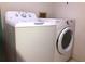 White laundry machines are side by side in this laundry room at 1313 S Pine Ridge Cir # C1, Sanford, FL 32773