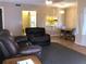 Cozy living room with an open view to the kitchen and dining area, furnished with a leather sofa set at 1313 S Pine Ridge Cir # C1, Sanford, FL 32773