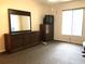 Bedroom featuring a window, ceiling fan, and dresser with mirror at 1313 S Pine Ridge Cir # C1, Sanford, FL 32773