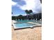 Community offers a pristine pool and jacuzzi surrounded by a brick patio and lush landscaping at 1313 S Pine Ridge Cir # C1, Sanford, FL 32773