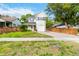 Well-maintained two-story home with a lush front lawn, brick driveway, and inviting red front door at 1419 East Amelia St, Orlando, FL 32803