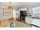 Well-lit kitchen features stainless steel appliances and white cabinetry at 1419 East Amelia St, Orlando, FL 32803