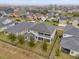 Aerial view of the fenced home showcasing a serene backyard pond at 16737 Meadows St, Clermont, FL 34714