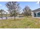 Landscaped backyard with lake view and black aluminum fence at 16737 Meadows St, Clermont, FL 34714