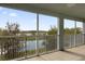 The large screened balcony offers a tranquil view of the pond and backyard at 16737 Meadows St, Clermont, FL 34714
