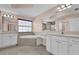 Elegant bathroom features double vanity, soaking tub, and neutral tile flooring at 16737 Meadows St, Clermont, FL 34714