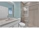 Bathroom with tile floors, single sink, and a tiled shower stall, designed for convenience and ease of use at 16737 Meadows St, Clermont, FL 34714