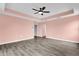 Large bedroom featuring a tray ceiling, wood-look flooring, and neutral paint at 16737 Meadows St, Clermont, FL 34714