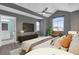 Modern bedroom with a large window, ceiling fan, and ensuite bathroom at 16737 Meadows St, Clermont, FL 34714