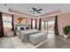 Well-lit bedroom with plush bed, tray ceiling, and sliding glass door to balcony at 16737 Meadows St, Clermont, FL 34714