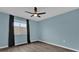 Simple bedroom featuring a ceiling fan, single window, and wood-look flooring at 16737 Meadows St, Clermont, FL 34714