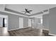 Spacious bedroom featuring a tray ceiling, ceiling fan, and wood-look flooring at 16737 Meadows St, Clermont, FL 34714