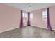 Bright bedroom with grey-toned floors, purple accents and two sunny windows at 16737 Meadows St, Clermont, FL 34714