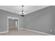 Dining room with tile floors, chandelier, and views into another room for Gathering gatherings and dinner parties at 16737 Meadows St, Clermont, FL 34714