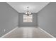 A well-lit dining room showcases tile floors, chandelier, and a bright, inviting space for gatherings at 16737 Meadows St, Clermont, FL 34714