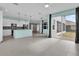 Open floor plan with a kitchen featuring stainless steel appliances, island, and easy access to outdoor spaces at 16737 Meadows St, Clermont, FL 34714