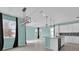 Spacious kitchen and dining area with tile floors, island, and modern light fixtures, offering ample space for entertaining at 16737 Meadows St, Clermont, FL 34714
