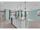 Well-lit kitchen island with sink, dishwasher, and stone countertops, offering convenient prep and cleaning space at 16737 Meadows St, Clermont, FL 34714