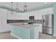 Bright kitchen featuring stainless steel appliances, white cabinets, and an island at 16737 Meadows St, Clermont, FL 34714