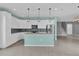 Bright kitchen featuring stainless steel appliances, white cabinets, and an island at 16737 Meadows St, Clermont, FL 34714