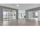 Bright living room with large sliding doors, tiled floors, and open floor plan at 16737 Meadows St, Clermont, FL 34714