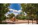 Community playground with slides and swings, set in a lush green space beneath a beautiful blue sky at 16737 Meadows St, Clermont, FL 34714