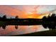 View of a peaceful backyard pond at sunset at 16737 Meadows St, Clermont, FL 34714