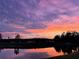 Beautiful sunset colors reflecting over a tranquil pond at 16737 Meadows St, Clermont, FL 34714