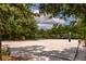 Enjoy a game of beach volleyball on the community's sand court surrounded by mature trees and lush vegetation at 16737 Meadows St, Clermont, FL 34714