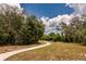 Scenic walking path winding through an open grassy area, perfect for a relaxing stroll in nature at 16737 Meadows St, Clermont, FL 34714