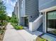 Side view of townhouses, showing walkway and landscaping at 1762 Mondrian Cir, Winter Park, FL 32789