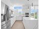 Modern white kitchen with island and stainless steel appliances at 1762 Mondrian Cir, Winter Park, FL 32789