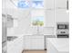 Modern white kitchen with marble backsplash at 1762 Mondrian Cir, Winter Park, FL 32789