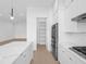 Modern white kitchen with pantry and stainless steel appliances at 1762 Mondrian Cir, Winter Park, FL 32789