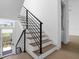Modern staircase with metal railing and light wood steps at 1762 Mondrian Cir, Winter Park, FL 32789