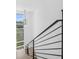 Modern staircase with metal railing and wood steps at 1762 Mondrian Cir, Winter Park, FL 32789