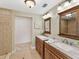 Bathroom with double vanity, granite countertop, and large mirror at 219 Nob Hill Cir, Longwood, FL 32779