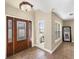 Bright entryway with tile floors, wood door, and large windows at 219 Nob Hill Cir, Longwood, FL 32779
