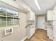 Laundry room with white cabinets, granite countertops, and a window at 219 Nob Hill Cir, Longwood, FL 32779