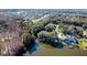 Aerial view of waterfront homes in a neighborhood surrounded by lush trees and landscaping at 2395 Windward Cv, Kissimmee, FL 34746