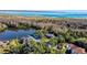 Beautiful waterfront property featuring mature landscaping and stunning lake views from above at 2395 Windward Cv, Kissimmee, FL 34746