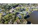 Overhead shot of lakefront houses with lush trees, offering stunning views of the water at 2395 Windward Cv, Kissimmee, FL 34746