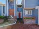Brick entryway with a red door and arched window at 2395 Windward Cv, Kissimmee, FL 34746