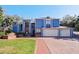 Two-story home with blue siding, brick driveway, and two-car garage at 2395 Windward Cv, Kissimmee, FL 34746